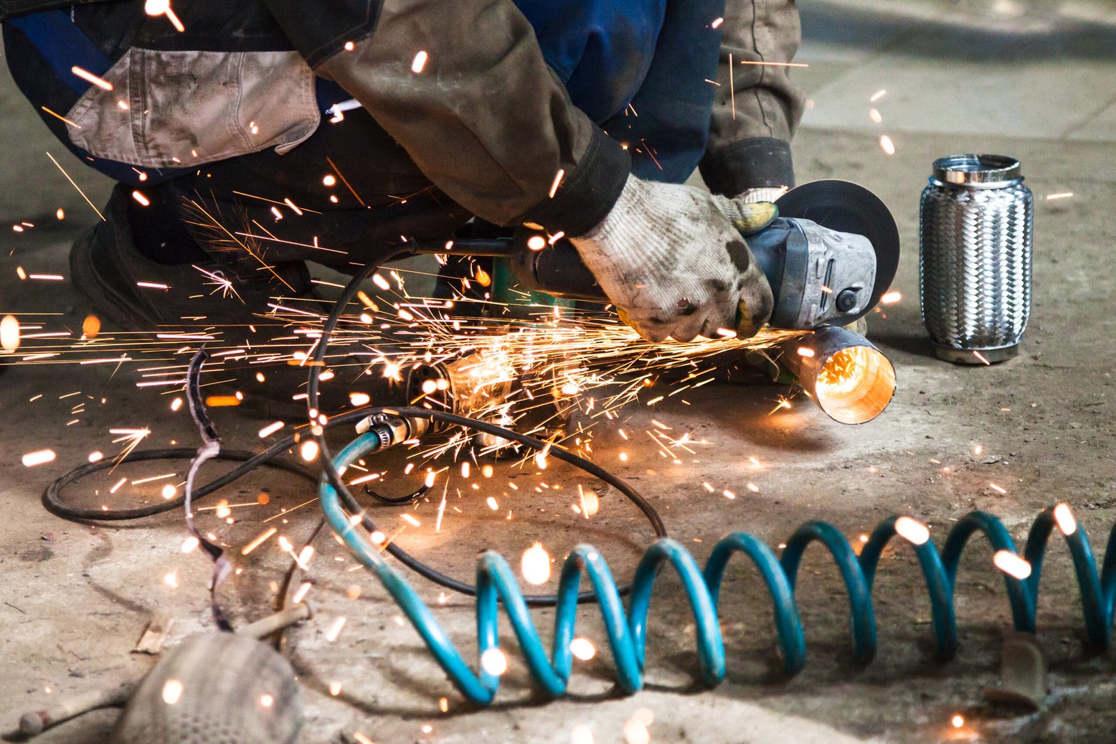 mechanic cuts new pipe for corrugation muffler 2024 10 16 03 36 39 utc scaled